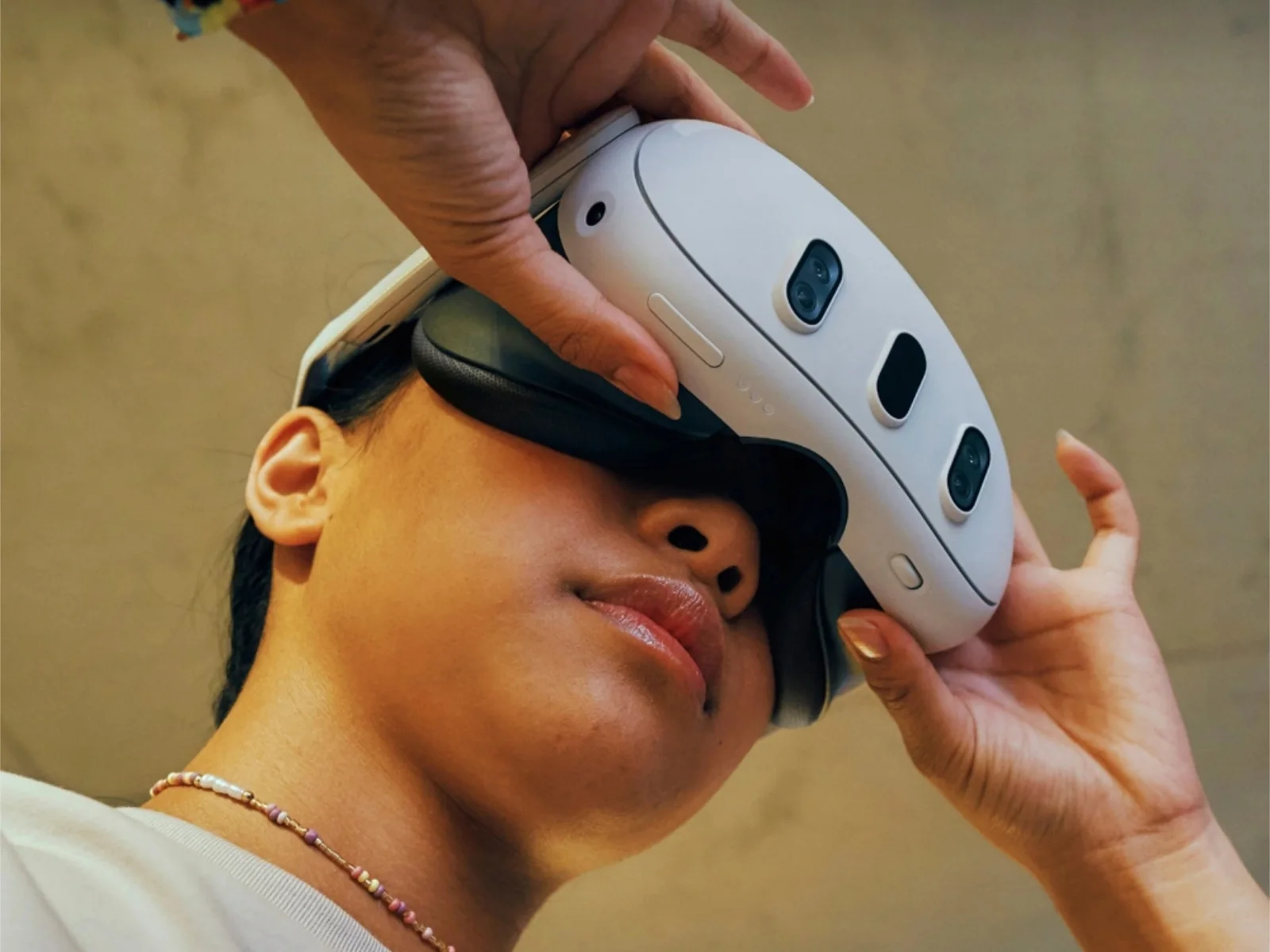 A patron settling a Meta Quest 3 headset into place for a guided Valen VR grounding session